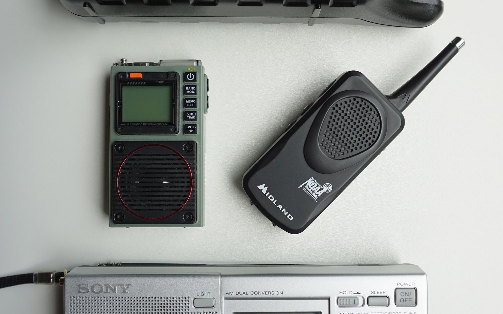 A collection of portable weather radios and alert devices