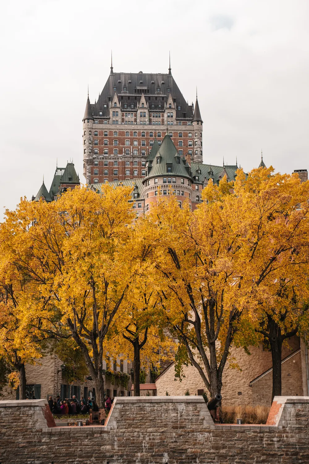 Château Frontenac rising above golden autumn trees in Québec City